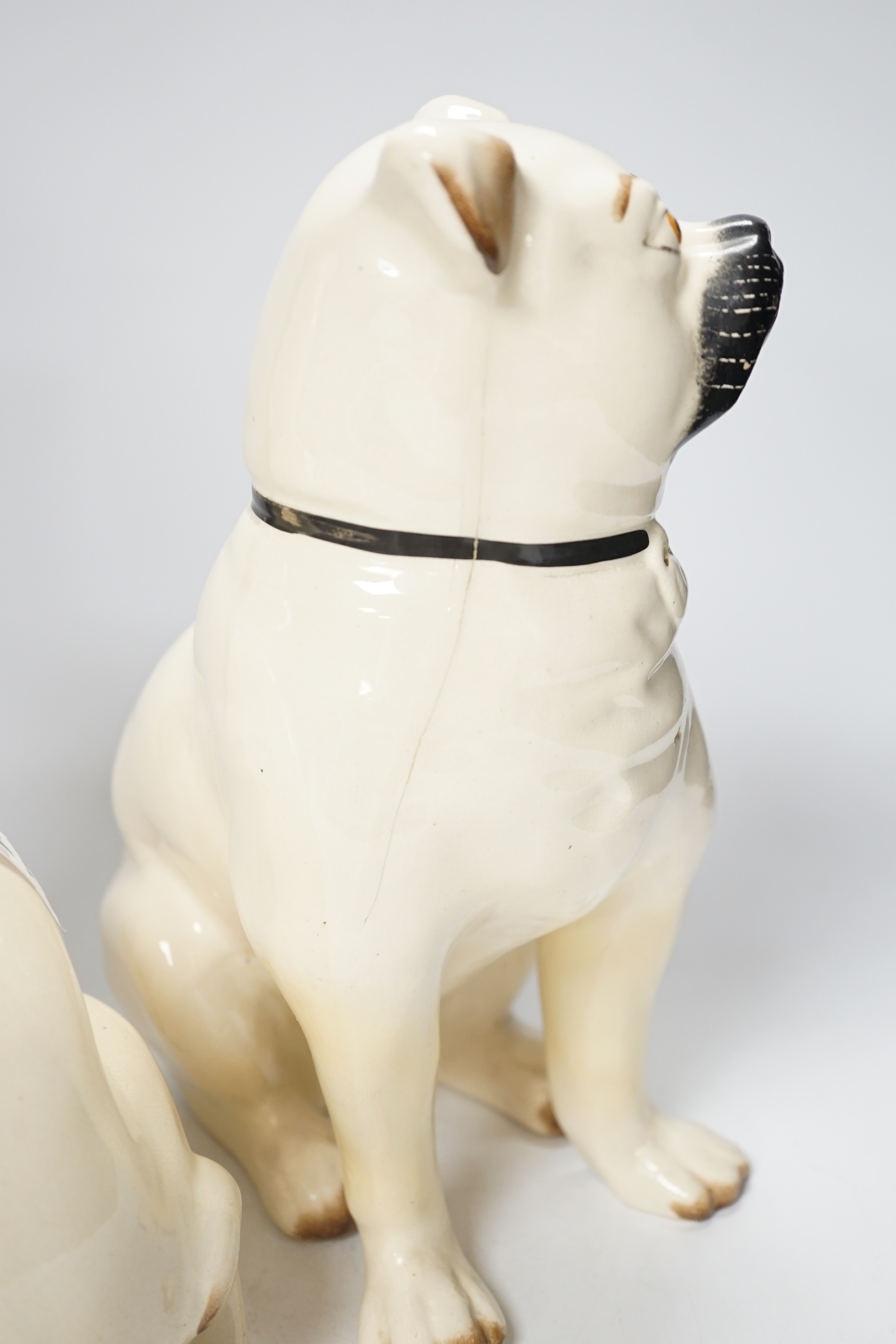 A pair of Staffordshire pug dogs, 28cm high